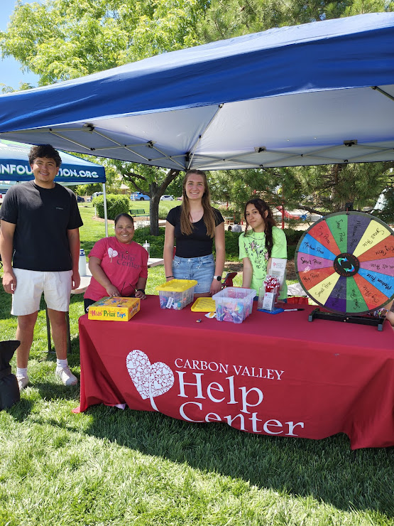 Carbon Valley Help Center volunteers at the Kids Day community event activity booth.